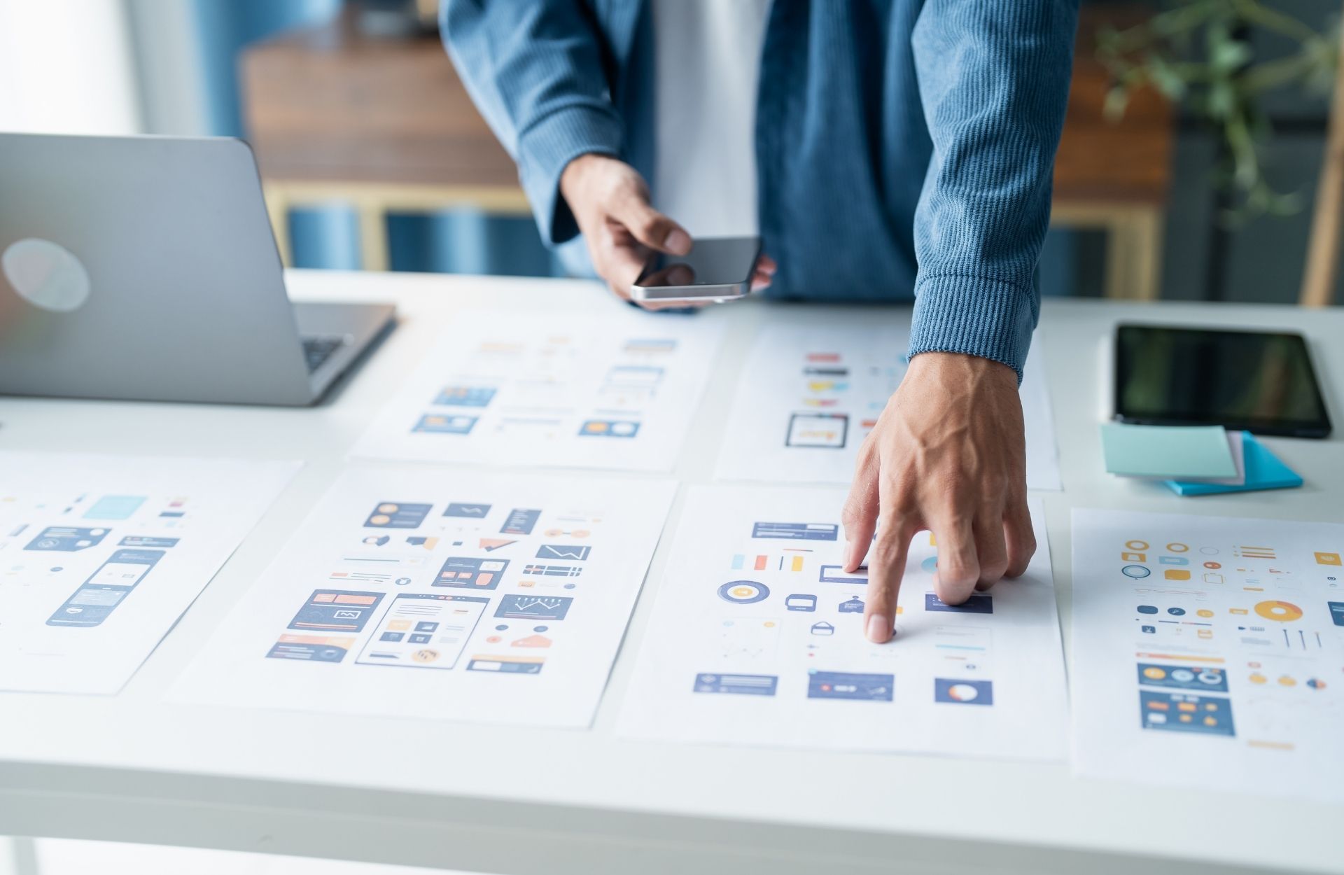 Designer reviewing website wireframes and mockups during a discovery session
